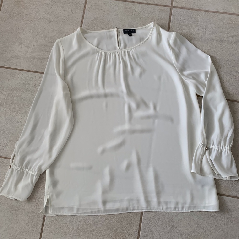 The Limited Lined Long Sleeve Ivory Blouse with back loop closure.